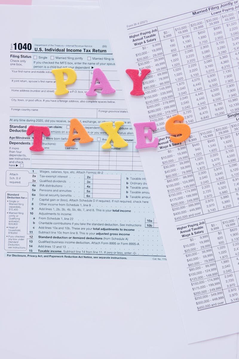 Colorful letters on tax forms, ideal for finance and tax-related themes.